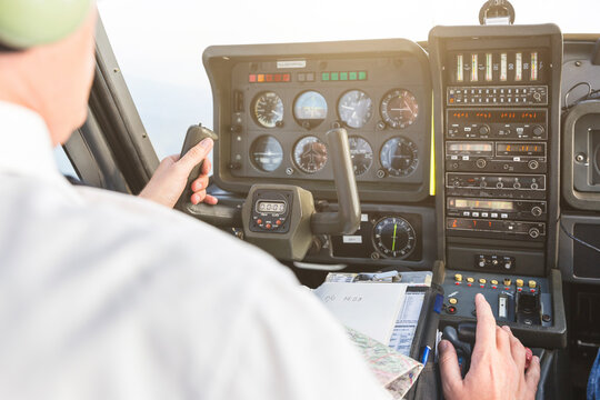 Pilot flying in sports plane, VFR chart on his lap