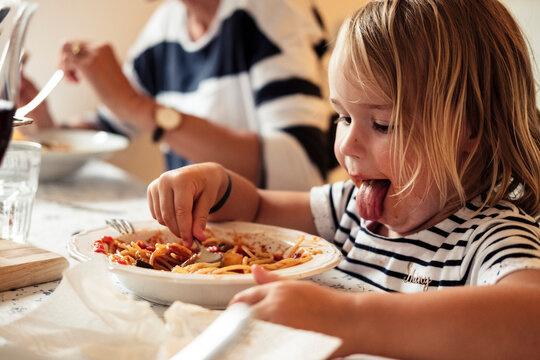 Portrait of little girl eating Spaghetti