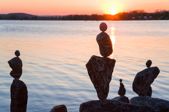 Rock stacks balancing on shore of&Ocirc;&oslash;&Omega;Lake Constance at sunset