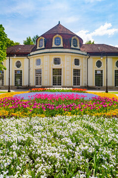 Germany, Bavaria, Bad Reichenhall, Colorful Flowerbed In Royal Spa Garden With Concert Hall Rotunda In Background