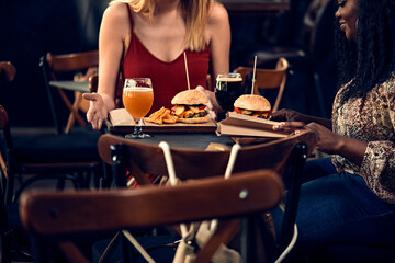 Female friends having a burger in a pub