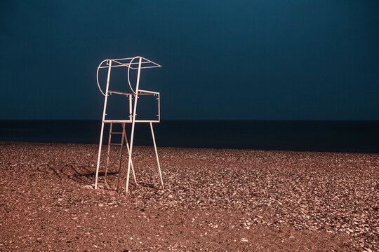 Georgia, Adjara, Batumi, Lifeguard chair on empty beach at night