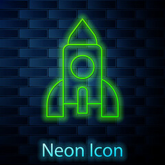 Glowing neon line Rocket ship toy icon isolated on brick wall background. Space travel. Vector