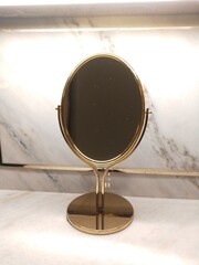 makeup mirror photo with gold frame and marble background