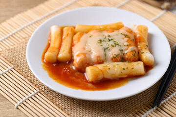 Korean food, Tteokbokki (sliced rice cakes) or tokpokki and sausage with cheese in spicy sauce