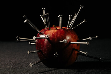 a red apple and nails on it