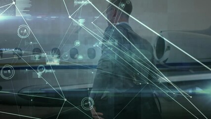 Animation of networks of connections over caucasian businessman walking at airport - Powered by Adobe