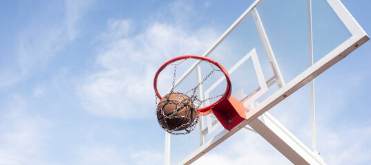 basketball hoop with an orange ball score through the net © Mihail