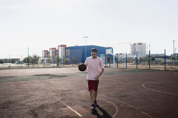 a basketball player holding ball on the court outside in the park