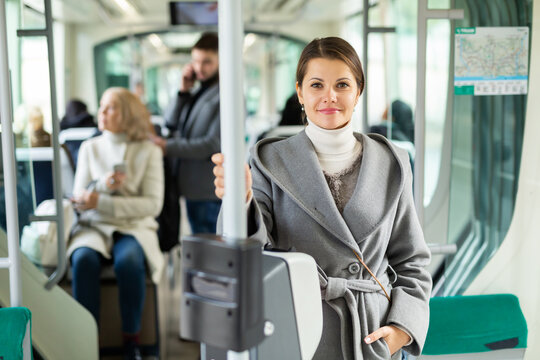 Portrait of positive female passenger traveling in tram. High quality photo