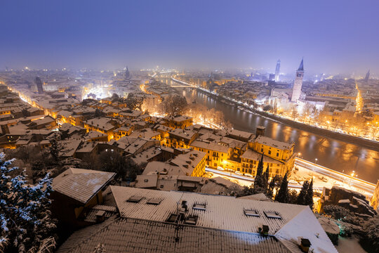 Italy, Verona, High angle view of city illuminated at night in Winter