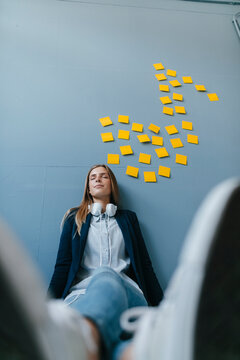 Young busensswoman relaxing, listening music
