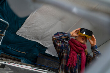 Amazed young woman wearing VR glasses