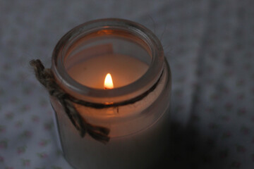 candle on a pink tablecloth