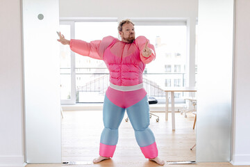 Bouncer in office wearing pink bodybuilder costume