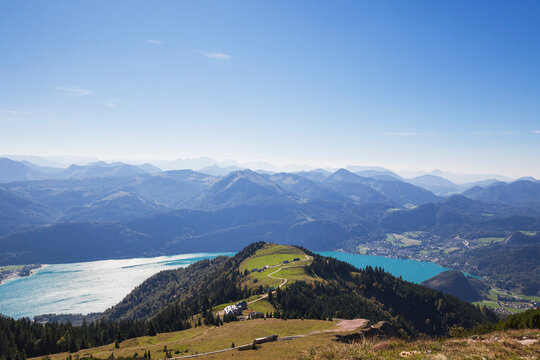Scenic view of Watzmann mountain with lake against blue sky on sunny day seen from Schafberg Railway