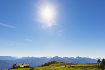 Scenic view of mountain range against blue sky on sunny day