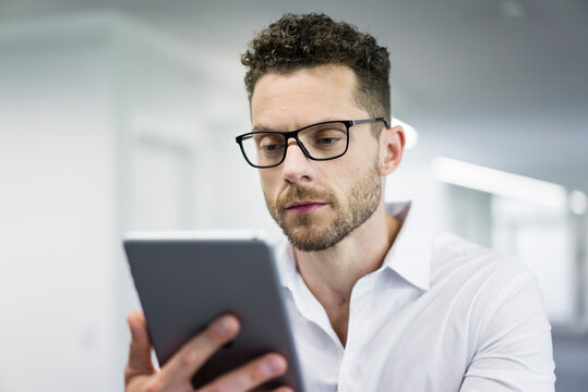 Businessman looking at tablet in office