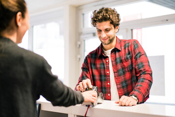 Man paying with credit card at the counter of a shop