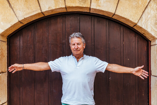 Portrait of a senior man in front of a wooden door