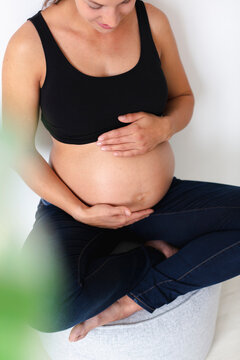 Young pregnant woman sitting on chair