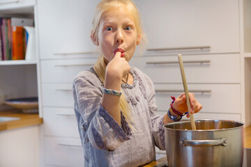 Portrait of girl cooking jam at home
