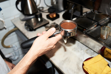 Fototapeta na wymiar Close-up of barista preparing coffee