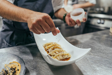 Chef garnishing bowl with food