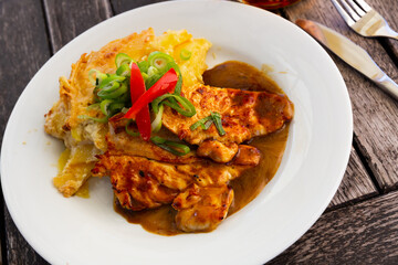 Fototapeta premium Czech dish - chicken with baked potato served with sauce and greens