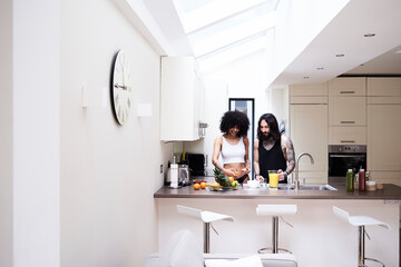 Young couple preparing healthy meal in kitchen