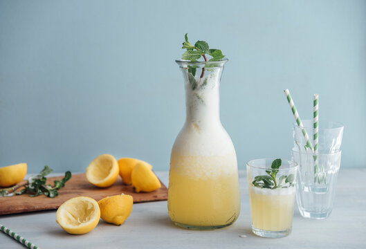 Homemade lemonade sweetened with honey in carafe and glass