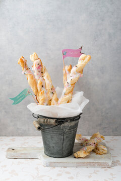 Puff paste sticks with sugar icing and granules