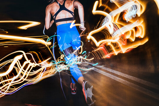 Woman running in the city at night