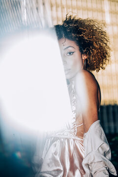 Portrait of attractive young woman with reflections wearing a dress