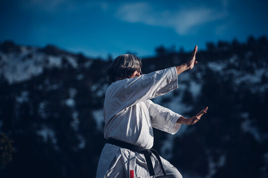 Senior man practicing karate outdoors
