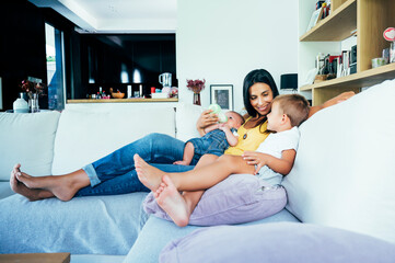 Mom with her two sons sitting on a sofa