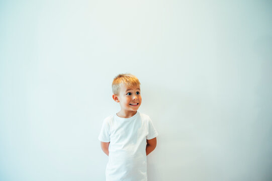 Boy posing in front of white background