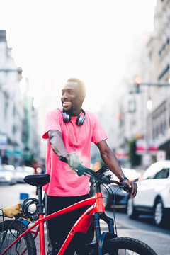 Smiling young man with e bike in the city