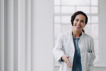 Female doctor reaching out hand for greeting