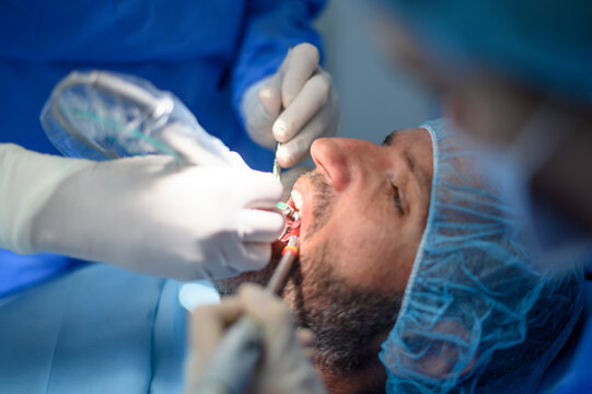 Dentist doctor performing a patient implant