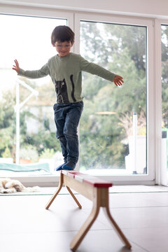 Little boy balancing on a beam