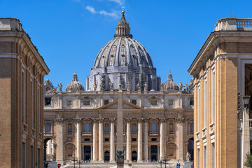 St. Peter's Basilica in city against blue sky on sunny day
