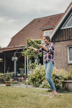 Woman playing diadolo in her garden