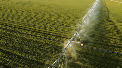 Aerial view of agricultural sprinkler spraying field