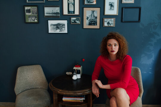 Portrait of red-haired woman sitting in a cafe