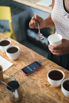 Close-up of woman working in a coffee roastery preparing coffee
