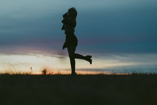Silhouette of woman in nature at sunset