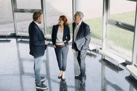 Business people talking at the window in modern office building
