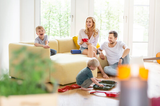 Happy family with two sons in living room of their new home