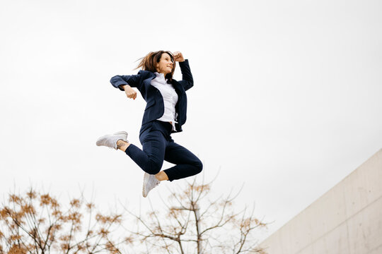 Happy businesswoman jumping in the city